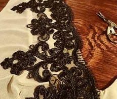 Black lace trim being placed on edge